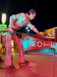 Photo of a fully 3-dimensional vintage sign, a lifelike representation of a man playing pool